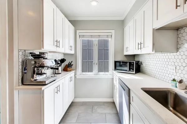a kitchen with a sink stove top oven and cabinets