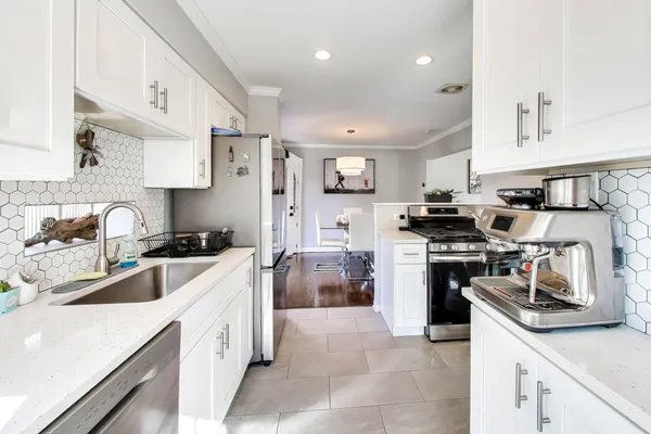 a kitchen with a sink stove and refrigerator
