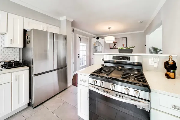 a kitchen with stainless steel appliances granite countertop a stove a refrigerator and a stove