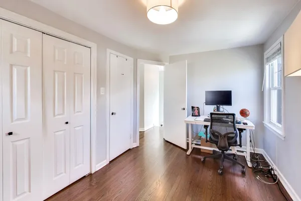 a view of a livingroom with workspace and a window
