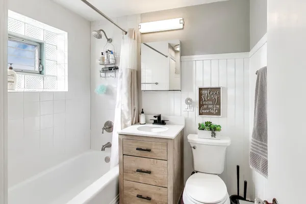 a bathroom with a sink toilet and shower