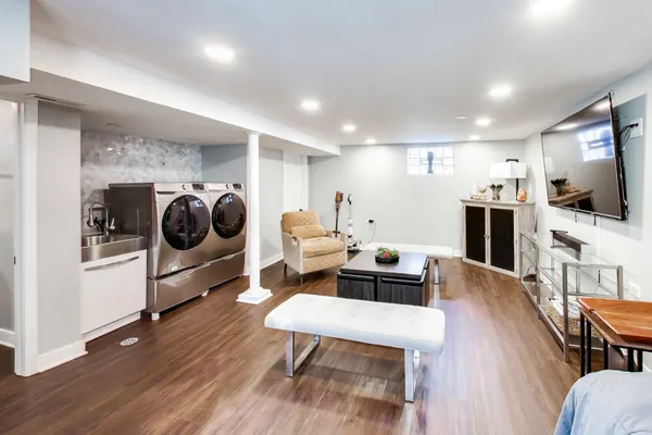 a living room with furniture and a wooden floor