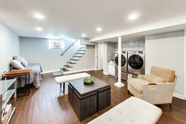 a living room with furniture and a wooden floor