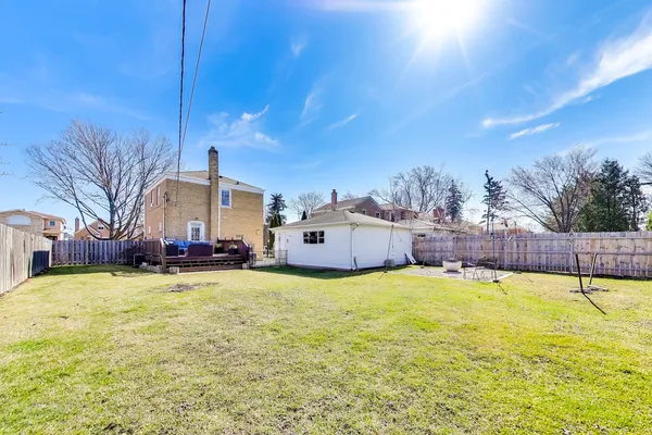 a view of a house with swimming pool and a yard