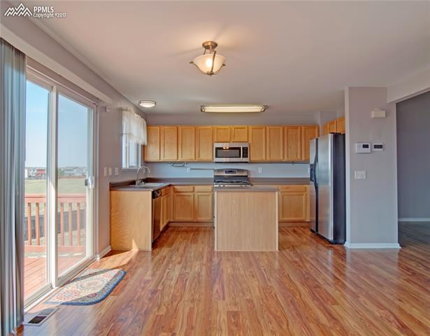 7680 Tompkins Road Peyton, CO 80831 - Photo 17 of 30 view of kitchen and open space from family room