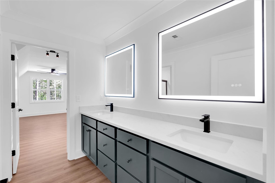 407 Blue Ridge Court Westminster, SC 29693 - Photo 32 of 48 This spacious primary bathroom features a double vanity and sleek, modern finishes.