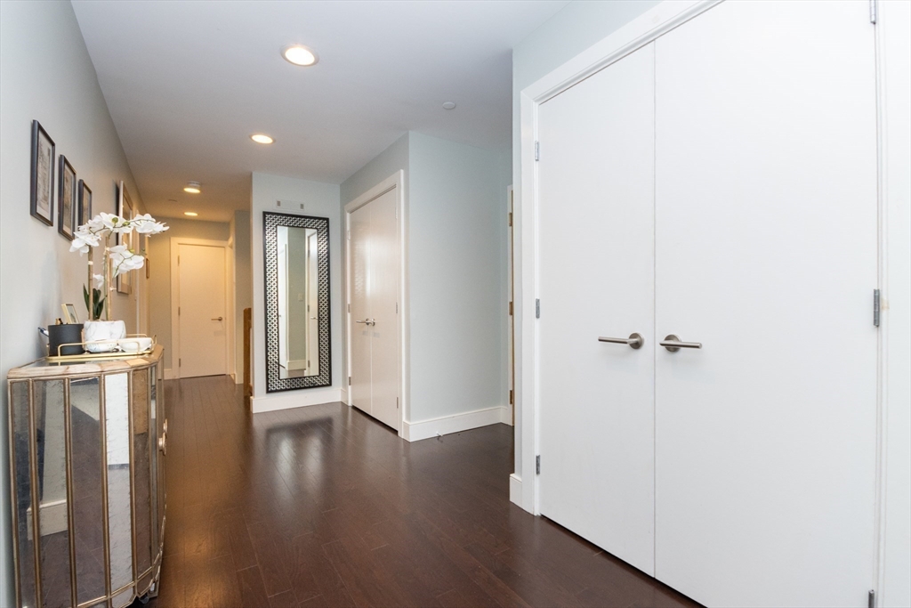 241 Perkins Street, Unit D302 Boston, MA 02130 - Photo 12 of 31 a view of a hallway with wooden floor