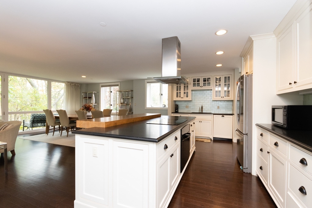 241 Perkins Street, Unit D302 Boston, MA 02130 - Photo 13 of 31 a kitchen with stainless steel appliances granite countertop a lot of counter space and wooden floors