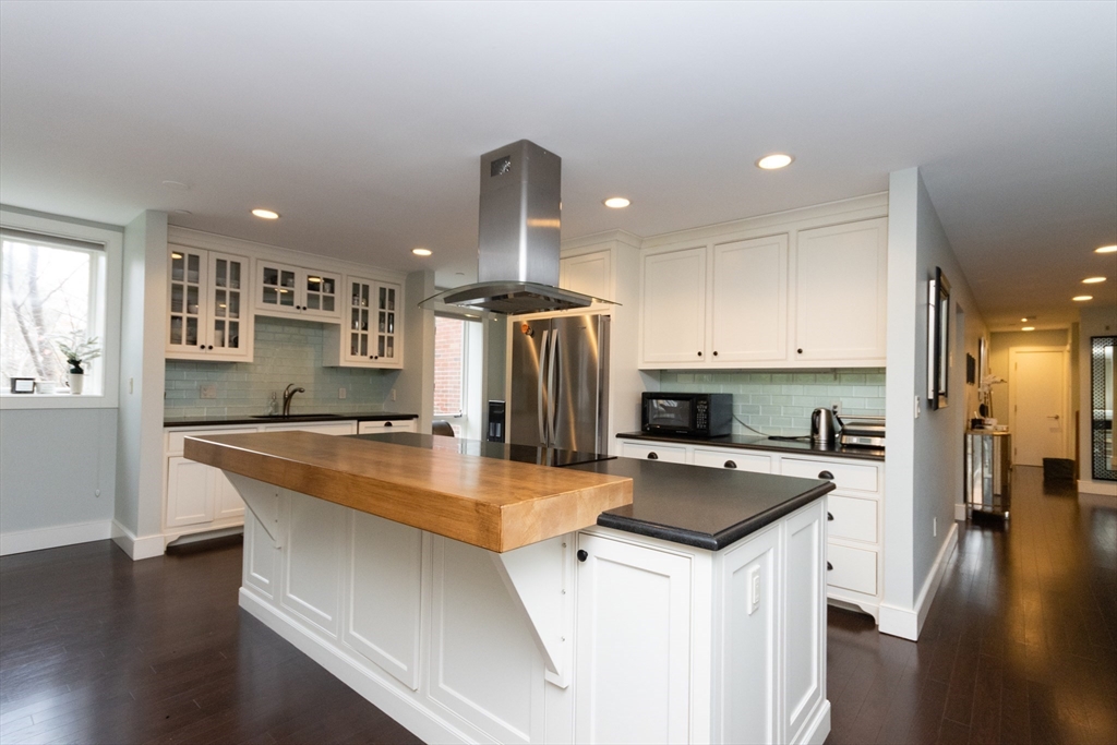 241 Perkins Street, Unit D302 Boston, MA 02130 - Photo 14 of 31 a kitchen with stainless steel appliances granite countertop a sink a stove and a refrigerator