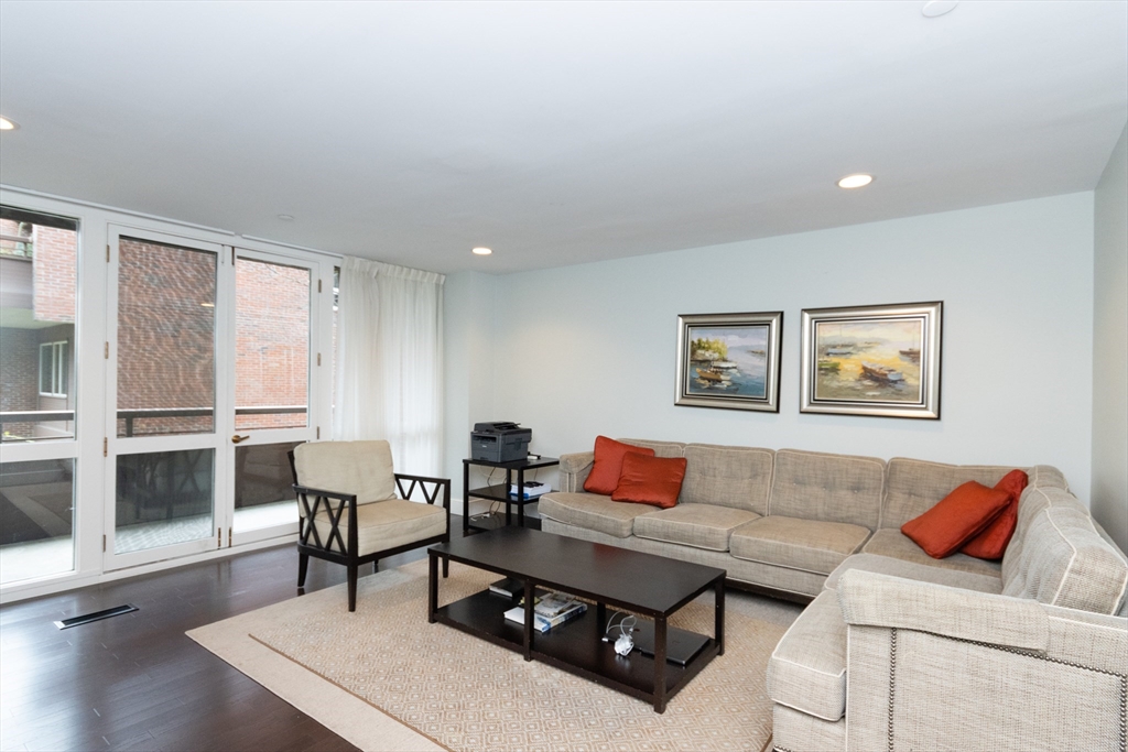 241 Perkins Street, Unit D302 Boston, MA 02130 - Photo 16 of 31 a living room with furniture a rug and a window