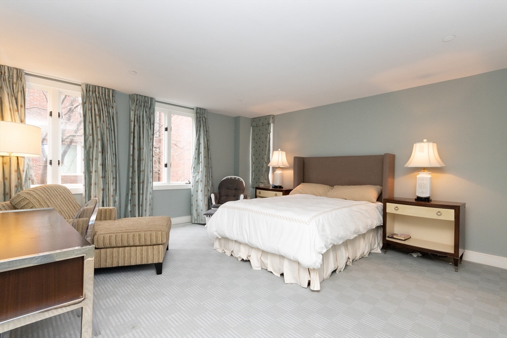 241 Perkins Street, Unit D302 Boston, MA 02130 - Photo 17 of 31 a spacious bedroom with a bed and a couch