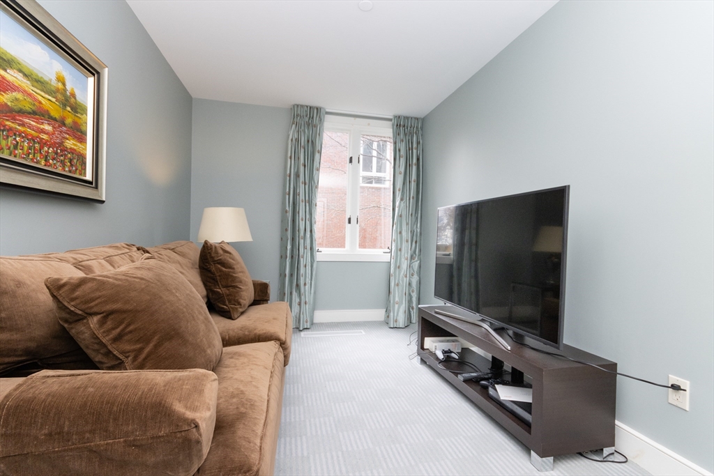 241 Perkins Street, Unit D302 Boston, MA 02130 - Photo 20 of 31 a living room with furniture and a flat screen tv