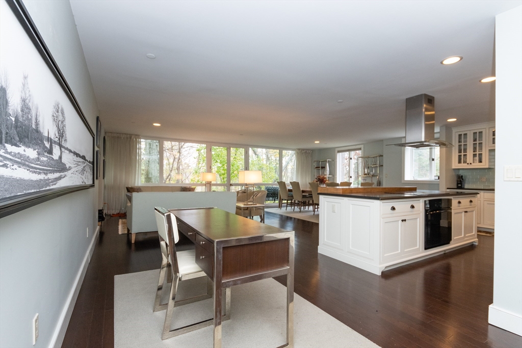 241 Perkins Street, Unit D302 Boston, MA 02130 - Photo 21 of 31 a kitchen with a table chairs and a refrigerator