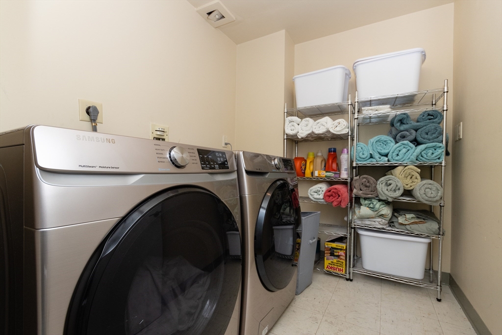 241 Perkins Street, Unit D302 Boston, MA 02130 - Photo 28 of 31 a utility room with dryer and washer