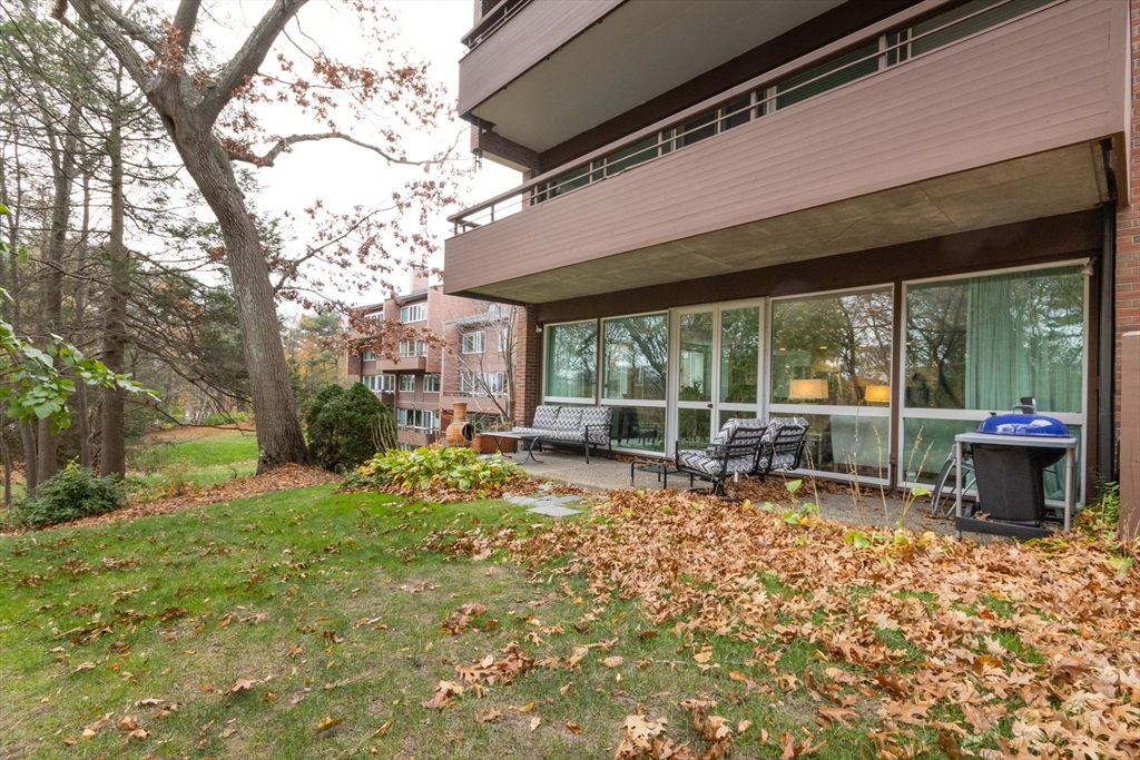 241 Perkins Street, Unit D302 Boston, MA 02130 - Photo 29 of 31 a view of a house with backyard sitting area and garden