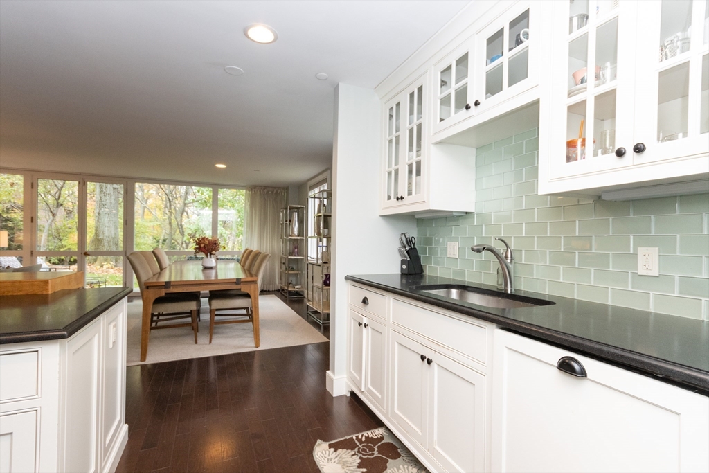 241 Perkins Street, Unit D302 Boston, MA 02130 - Photo 7 of 31 a kitchen with stainless steel appliances granite countertop a sink and a white cabinets