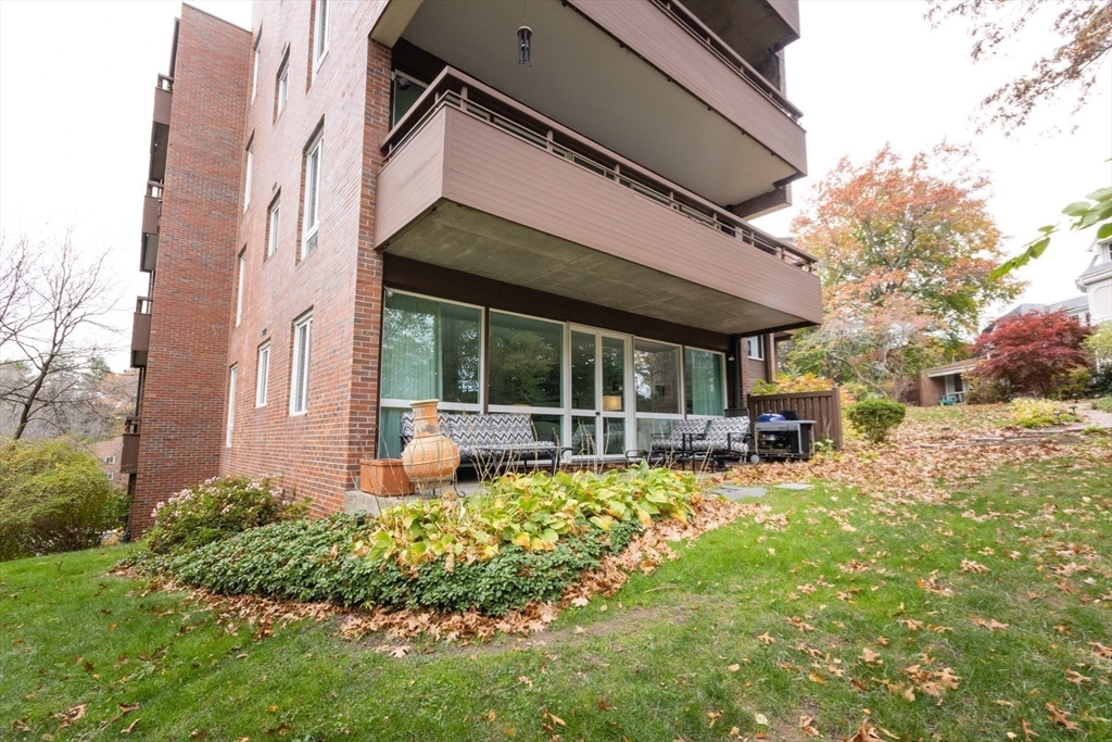241 Perkins Street, Unit D302 Boston, MA 02130 - Photo 8 of 31 a view of a house with backyard sitting area and garden