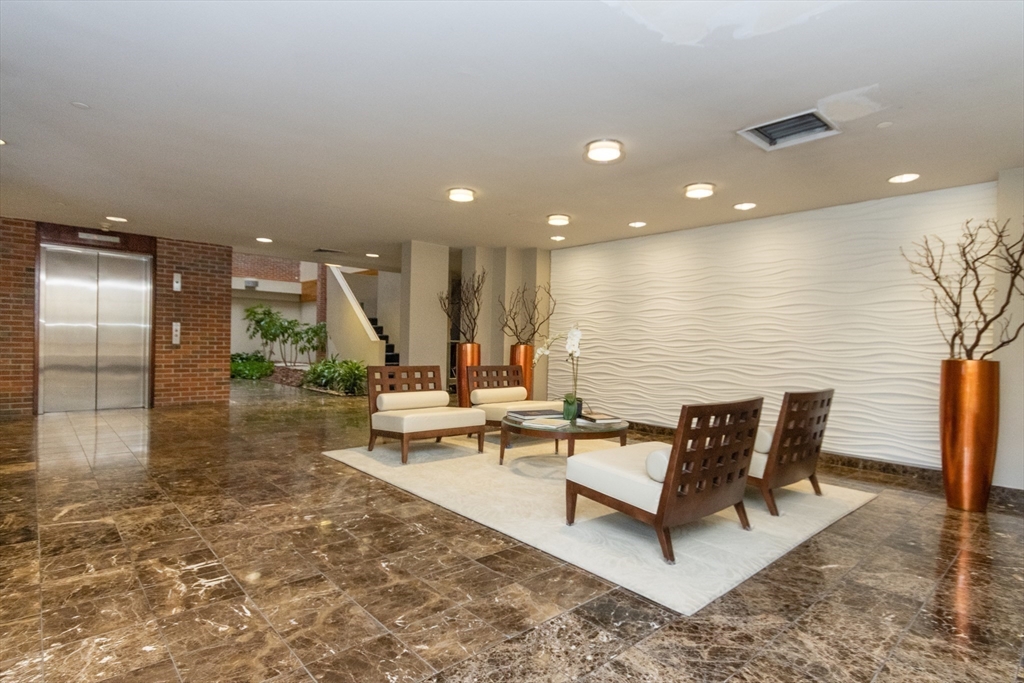 241 Perkins Street, Unit D302 Boston, MA 02130 - Photo 10 of 31 a view of a lobby with chair and wooden floor