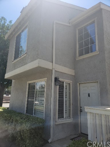 182 West Walnut Avenue, Unit A Rialto, CA 92376 - Photo 1 of 1 a front view of a house with a yard