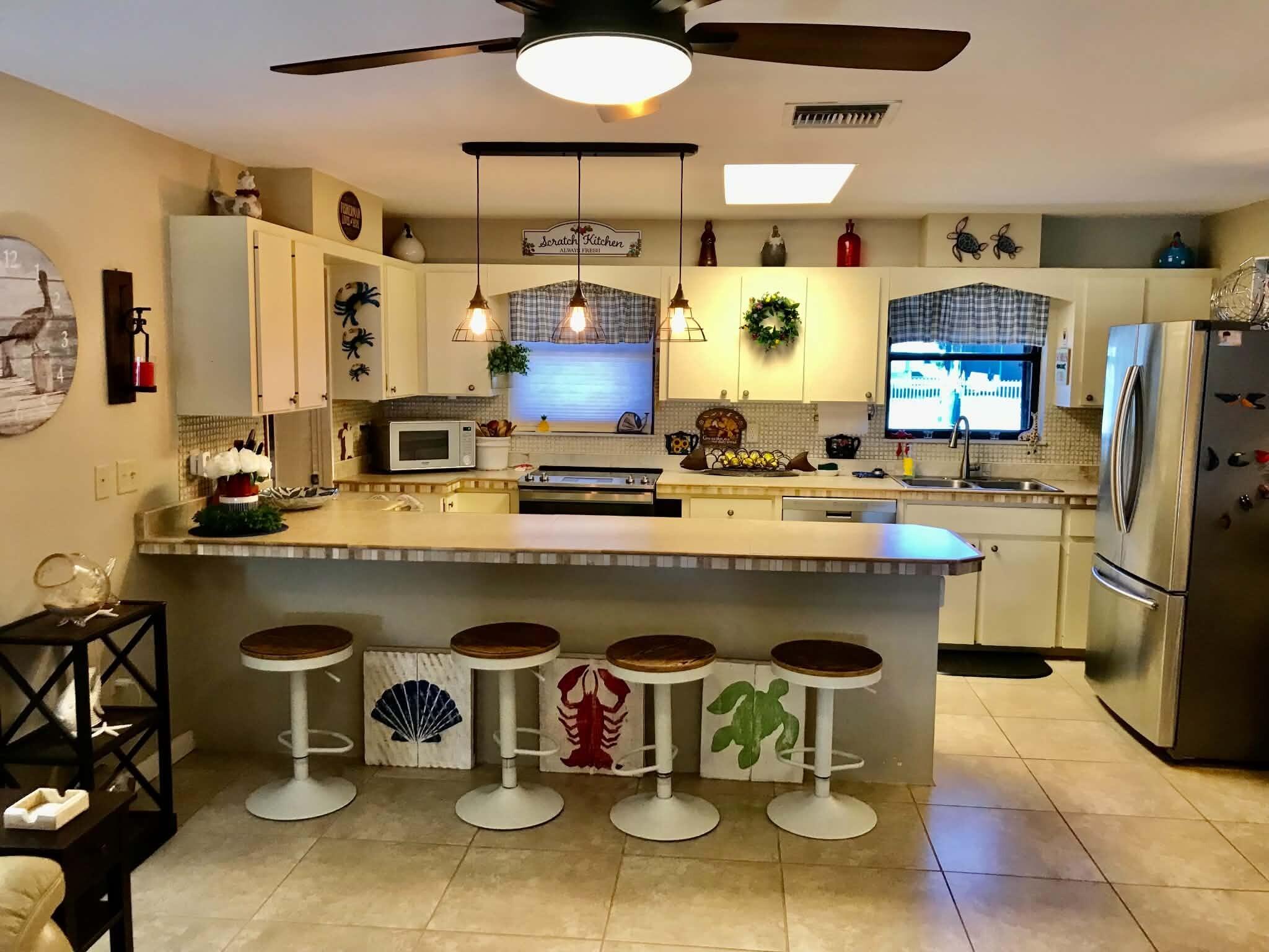 1115 Elm Street Okeechobee, FL 34974 - Photo 11 of 37 a kitchen with a sink cabinets and appliances