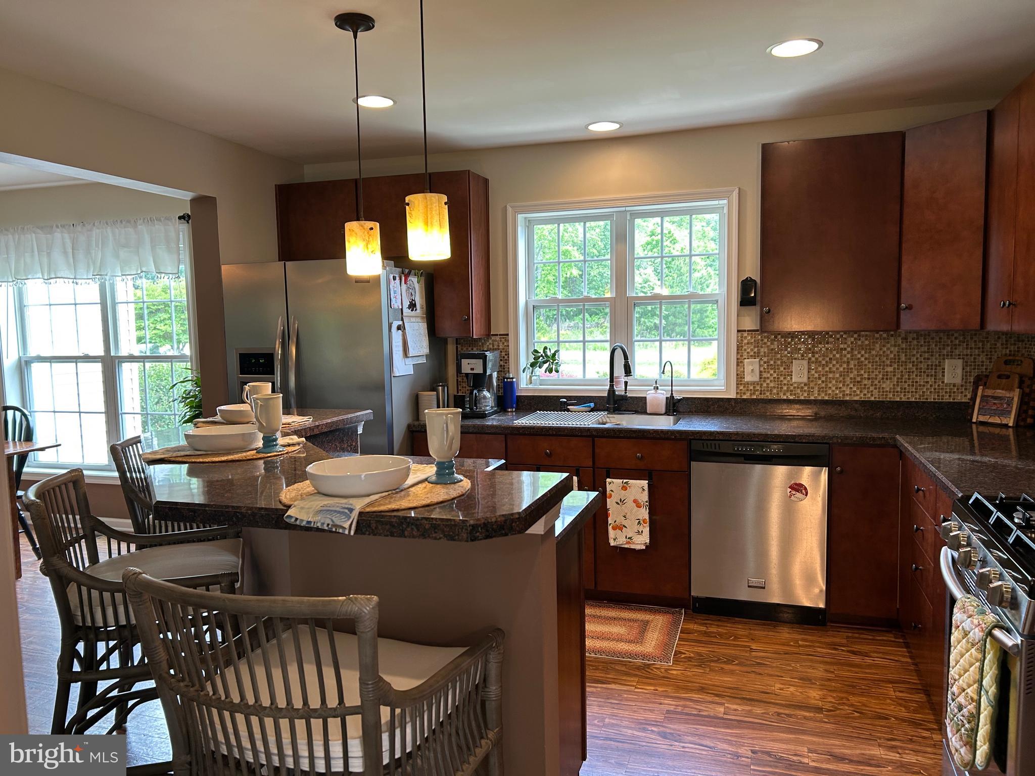 20346 Cool Spring Road Milton, DE 19968 - Photo 29 of 69 a kitchen with a dining table chairs and sink