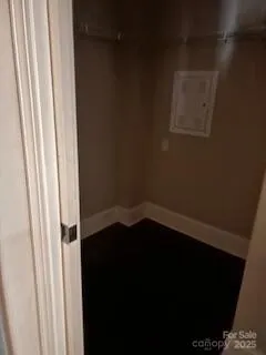 a small space with wooden floor and a window