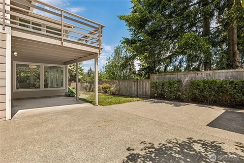 a backyard of a house with a basket ball court