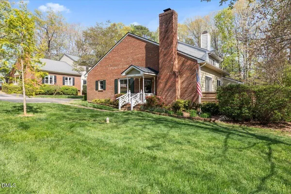 a front view of a house with a garden and plants