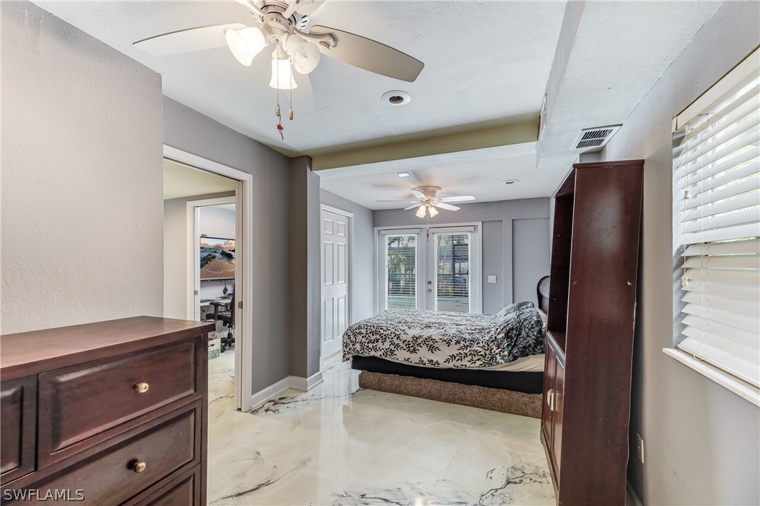 2885 Triggerfish Street Cape Coral, FL 33993 - Photo 11 of 35 a very nice looking room with a large window and chandelier