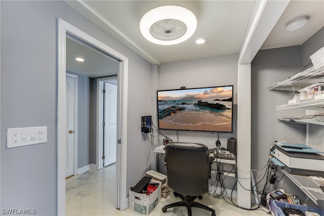 2885 Triggerfish Street Cape Coral, FL 33993 - Photo 12 of 35 a view of a workspace with furniture and a fan