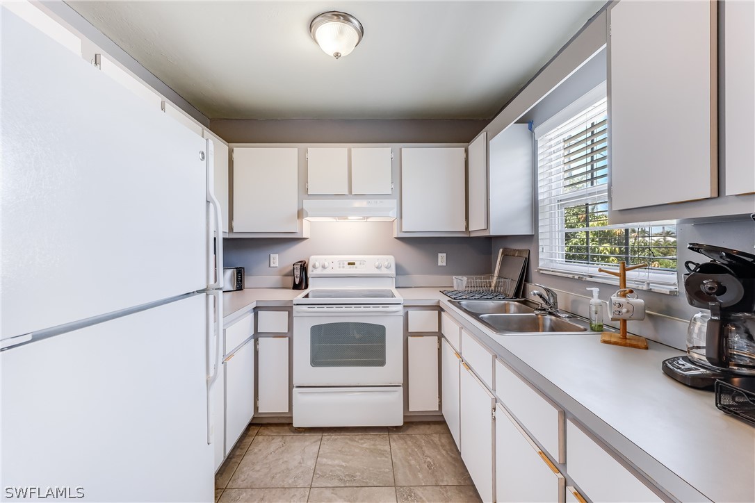 2885 Triggerfish Street Cape Coral, FL 33993 - Photo 25 of 35 a kitchen with a sink cabinets and window