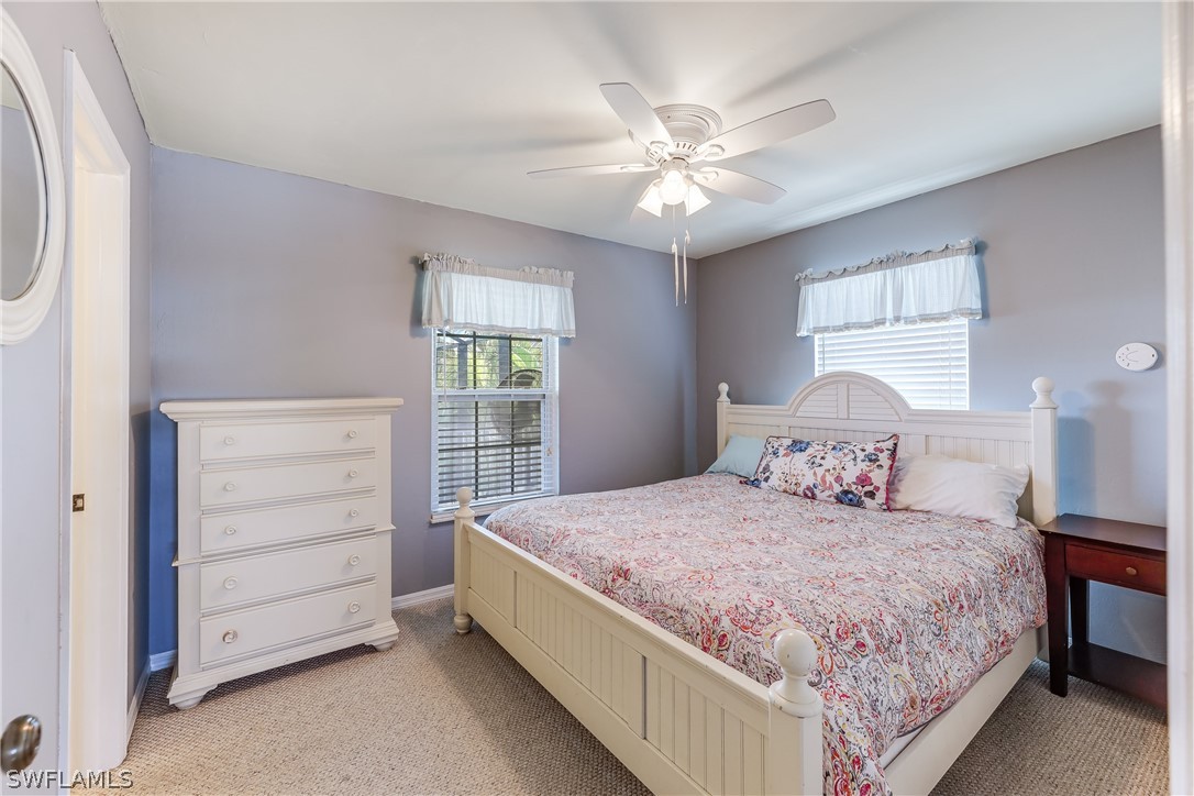 2885 Triggerfish Street Cape Coral, FL 33993 - Photo 29 of 35 a bedroom with a bed a dresser and a window