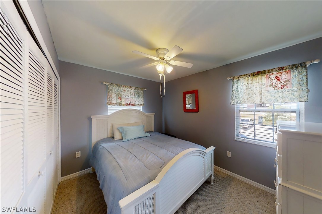 2885 Triggerfish Street Cape Coral, FL 33993 - Photo 30 of 35 a bedroom with a bed and a chandelier