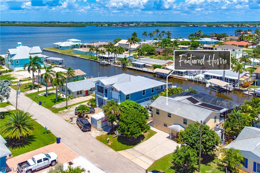 2885 Triggerfish Street Cape Coral, FL 33993 - Photo 3 of 35 an aerial view of a house with a lake view