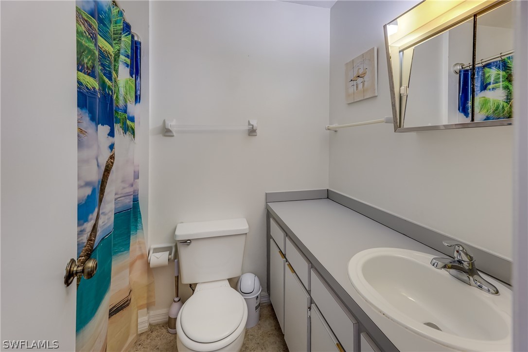 2885 Triggerfish Street Cape Coral, FL 33993 - Photo 31 of 35 a bathroom with a sink toilet and vanity