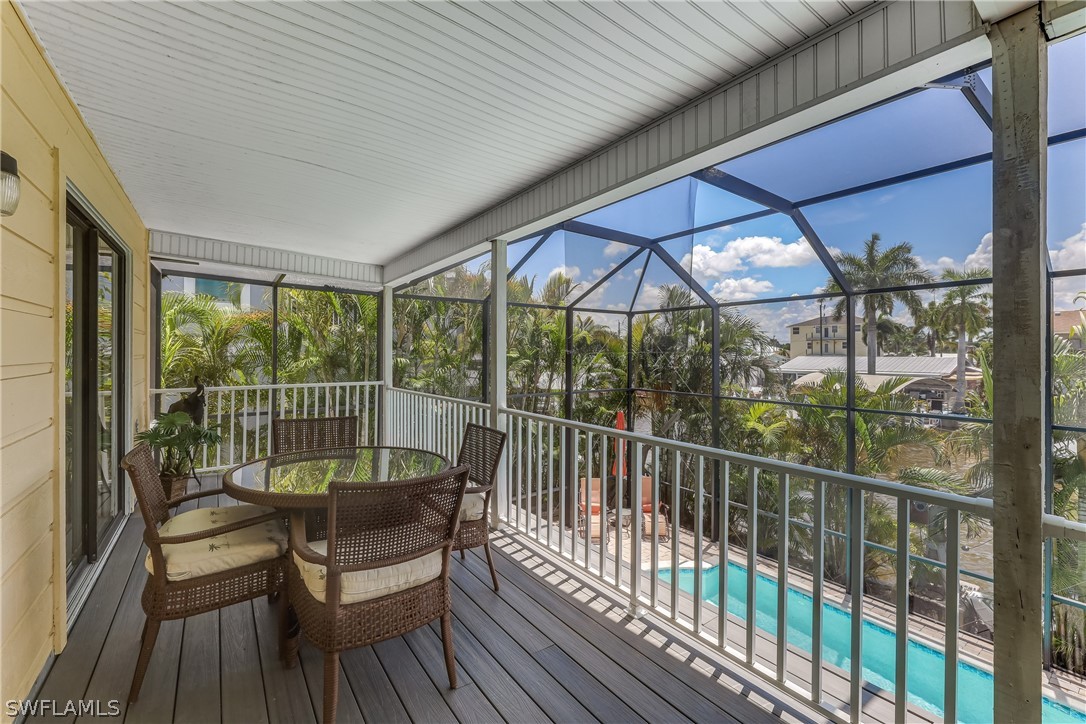2885 Triggerfish Street Cape Coral, FL 33993 - Photo 32 of 35 a view of a balcony with furniture and wooden deck