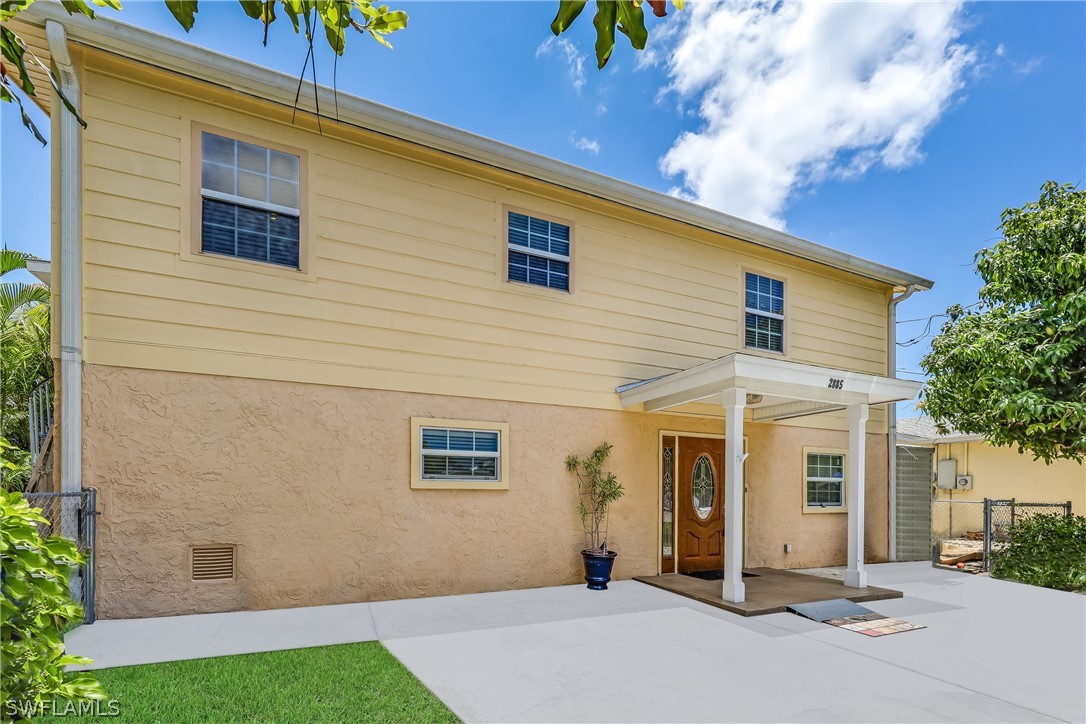 2885 Triggerfish Street Cape Coral, FL 33993 - Photo 4 of 35 a front view of a house with a yard