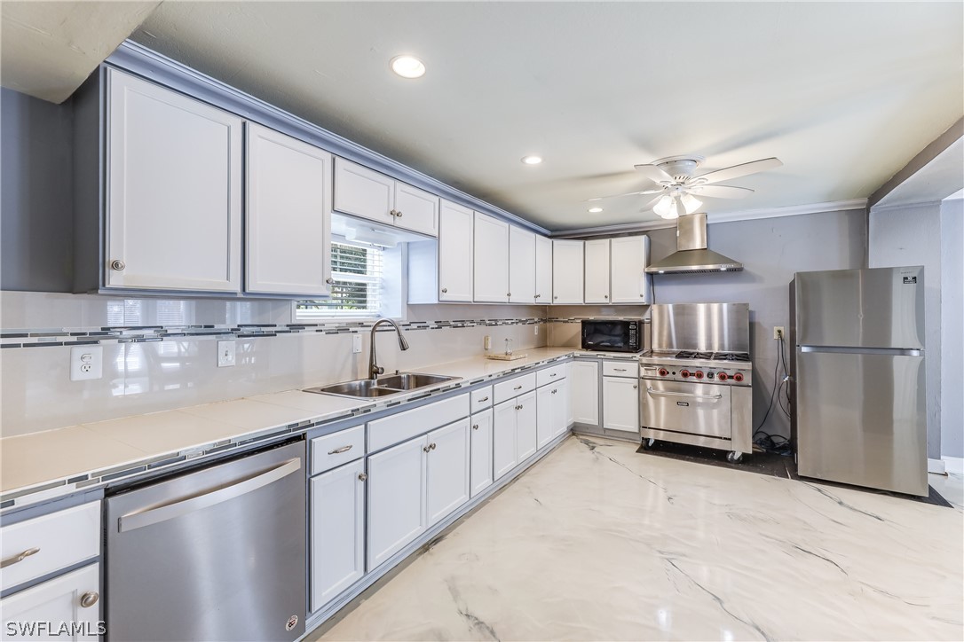 2885 Triggerfish Street Cape Coral, FL 33993 - Photo 6 of 35 a kitchen with refrigerator cabinets and a sink