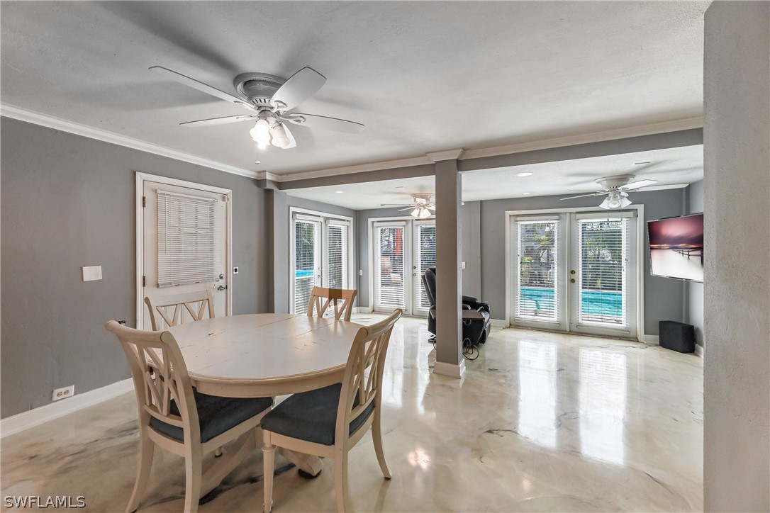 2885 Triggerfish Street Cape Coral, FL 33993 - Photo 9 of 35 a view of a dining room with furniture and chandelier