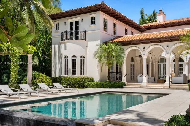 a view of swimming pool with a couches in a patio