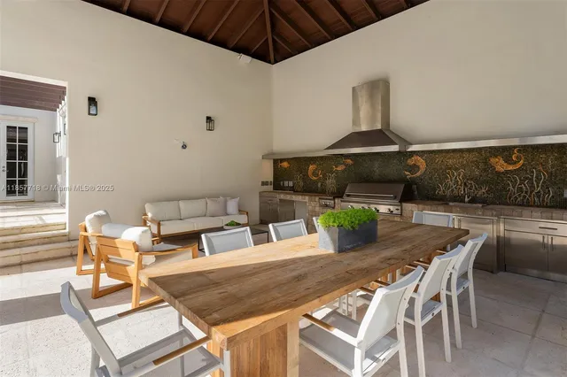 a living room with furniture a fireplace and a chandelier
