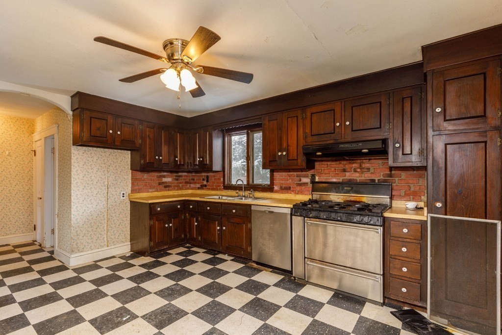4 Capitol Street Methuen, MA 01844 - Photo 2 of 12 a kitchen with stainless steel appliances granite countertop a sink stove and refrigerator