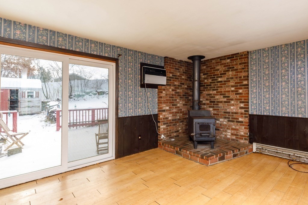 4 Capitol Street Methuen, MA 01844 - Photo 3 of 12 a bedroom with a bed and a fireplace