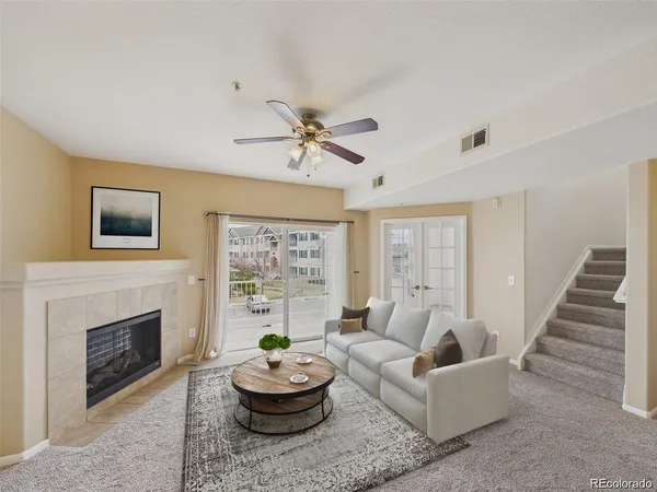 a living room with furniture a window and a fireplace