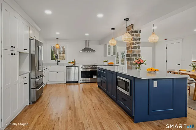 a kitchen with stainless steel appliances a stove top oven and a refrigerator