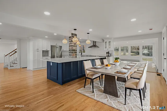a kitchen with a table chairs and wooden floor