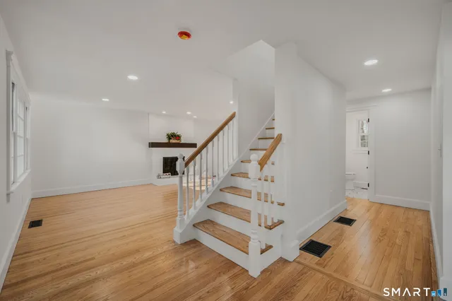 a view of entryway with stairs and wooden floor