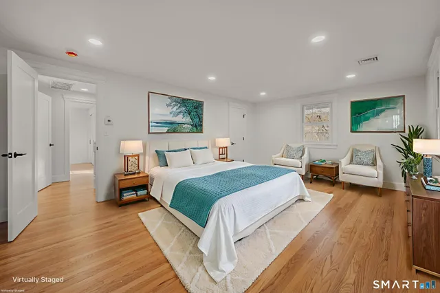 a bedroom with bed and wooden floor