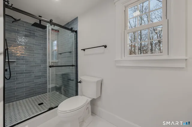 a bathroom with a toilet and shower