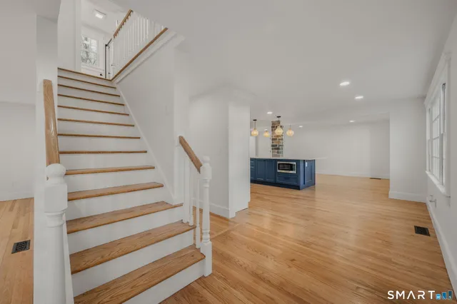 a view of a room with wooden floor and stairs
